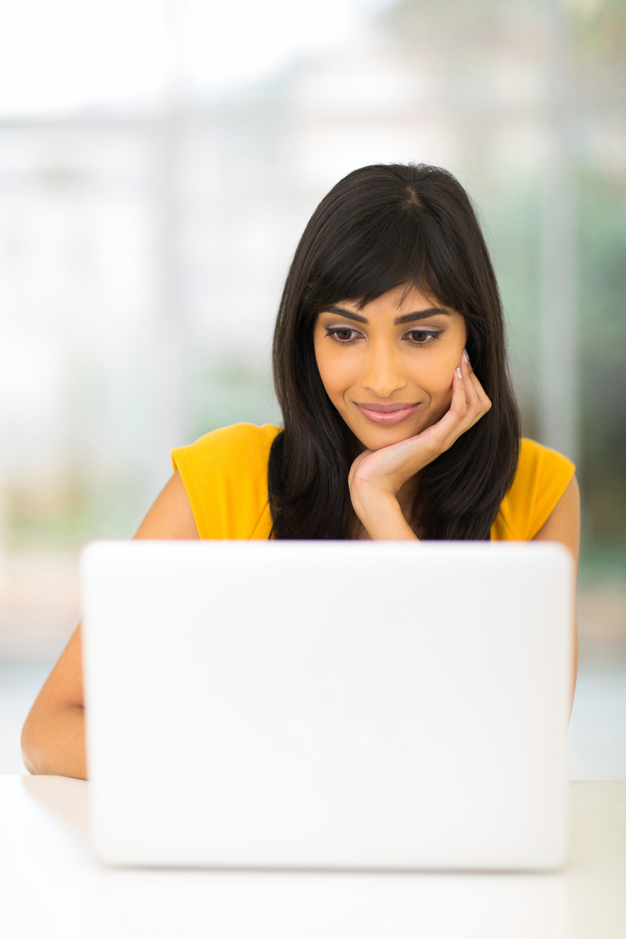 indian woman looking at computer screen